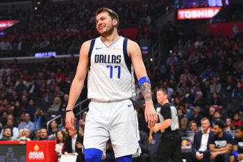 Dallas Mavericks basketball player Luka Doncic smiles during a game.