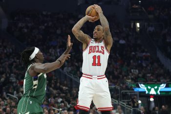 DeMar DeRozan shoots over Jrue Holiday.