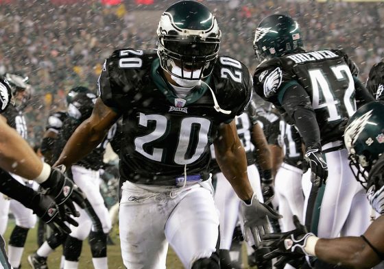 Brian Dawkins runs on to the field wearing a black visor