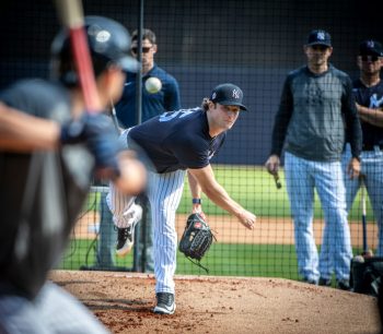 New York Yankees pitcher Gerrit Cole, manager Aaron Boone, and coach Carlos Mendoza at spring training