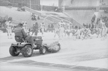 Man Operating Power Brush Snow Sweeper