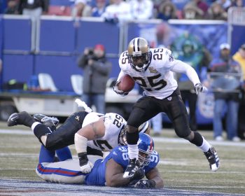 Reggie Bush breaks away from New York Giants defensive tackle Fred Robbins.