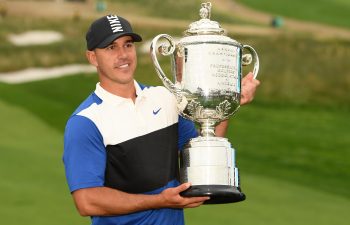 Brooks Koepka holding a trophy after winning a PGA event