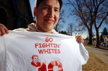 WHITE--3-11-02--Solomon Little Owl, director of Native American Student Services at the University of Northern Colorado, holds up the team T-shirt he had printed, somewhat humorously, for his intramural basketaball team. Some American Indian students at t