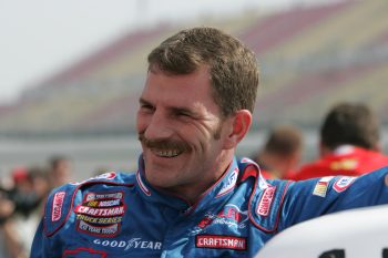 Driver Kerry Earnhardt smiles as he exits his vehicle post-race