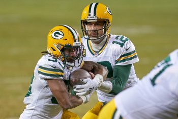 Aaron Rodgers hands the ball off to Packers RB Aaron Jones during a game against the Chicago Bears from the 2020 season.