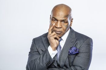 Mike Tyson poses for a photo in a suit