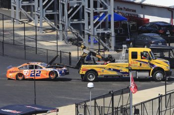 Joey Logano's car is towed to garage