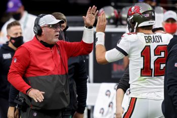 Tampa Bay Buccaneers head coach Bruce Arians greets Tom Brady as he walks off the field.