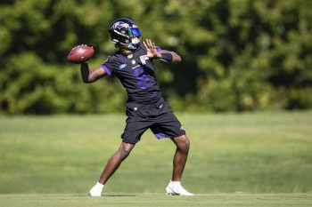 Lamar Jackson of the Baltimore Ravens throws during mandatory minicamp before the 2021 NFL season where he will be the NFL's 400th highest-paid player.