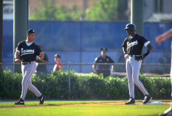 Michael Jordan stands on third base with manager Terry Francona coaching third.