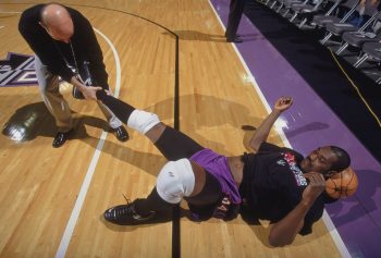 Hakeem Olajuwon stretches before a game as a member of the Toronto Raptors.