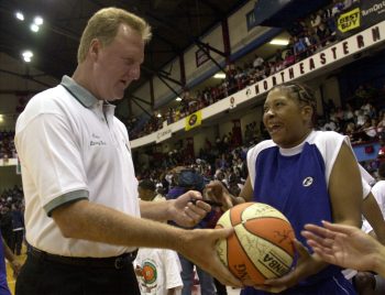 Larry Bird signs an autograph.