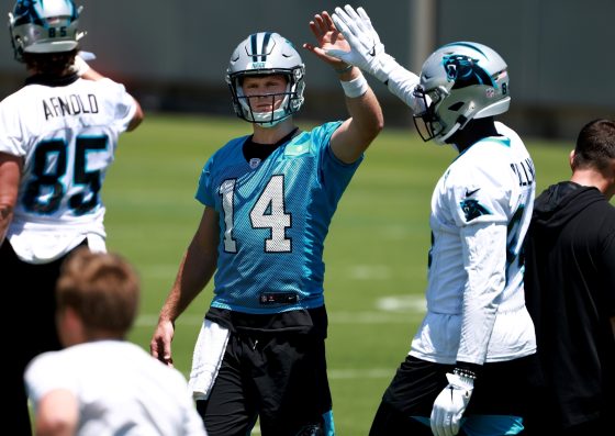 Carolina Panthers quarterback Sam Darnold high-fives teammate Stephen Sullivan during practice.