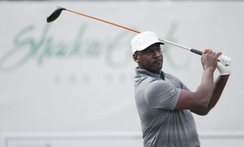 NBA legend Michael Jordan takes a swing during a golf tournament.