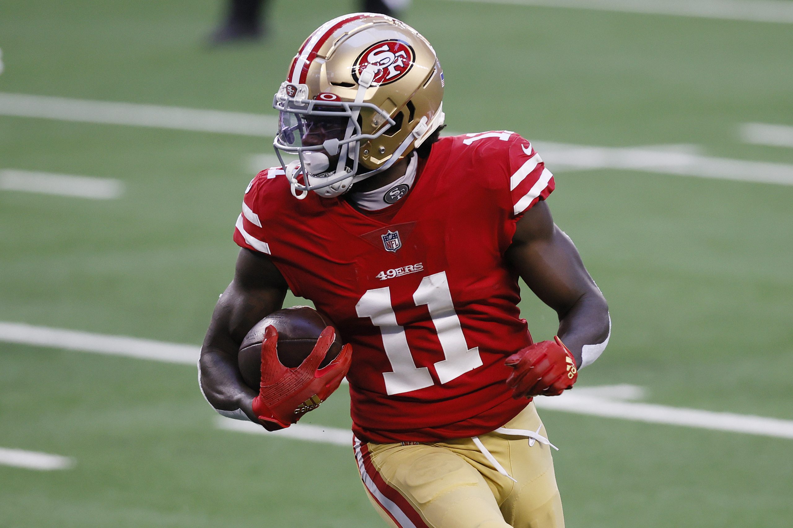 Brandon Aiyuk runs with the football during NFL game