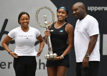 Coco Gauff (C) and her parents, Corey (R) and Candi (L), celebrate victory together.