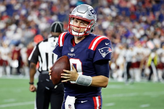 New England Patriots quarterback Mac Jones gets ready before a preseason game.