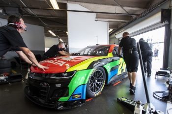 Team members push the No. 24 NASCAR Next Gen car driven by William Byron out of the garage during the NASCAR Cup Series test at Daytona International Speedway on Sept. 7, 2021.