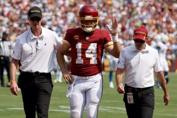 Ryan Fitzpatrick of the Washington Football Team leaves the field after being injured during the first half against the Los Angeles Chargers at FedExField on September 12, 2021 in Landover, Maryland. He was replaced by Taylor Heinicke.