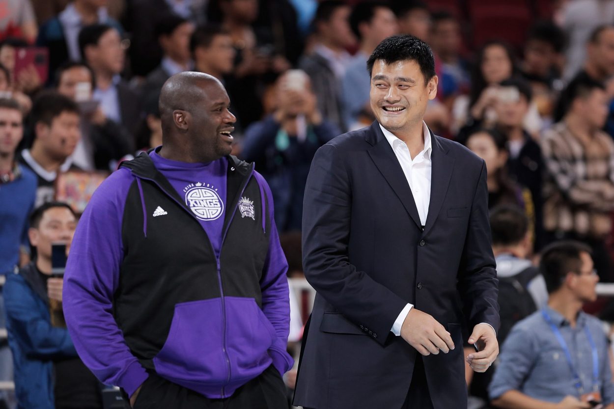 Shaq kindly helped Yao Ming put on his Hall of Fame jacket, since