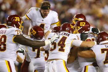 Washington Football Team quarterback Taylor Heinicke celebrates a win over the New York Giants with his teammates.