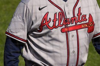 The All-Star Game logo is covered up on the right sleeve of manager Brian Snitker of the Atlanta Braves during a baseball game against the Philadelphia Phillies at Citizens Bank Park on April 4, 2021.
