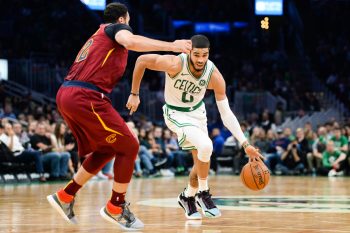 Jayson Tatum of the Boston Celtics drives past Larry Nance Jr.