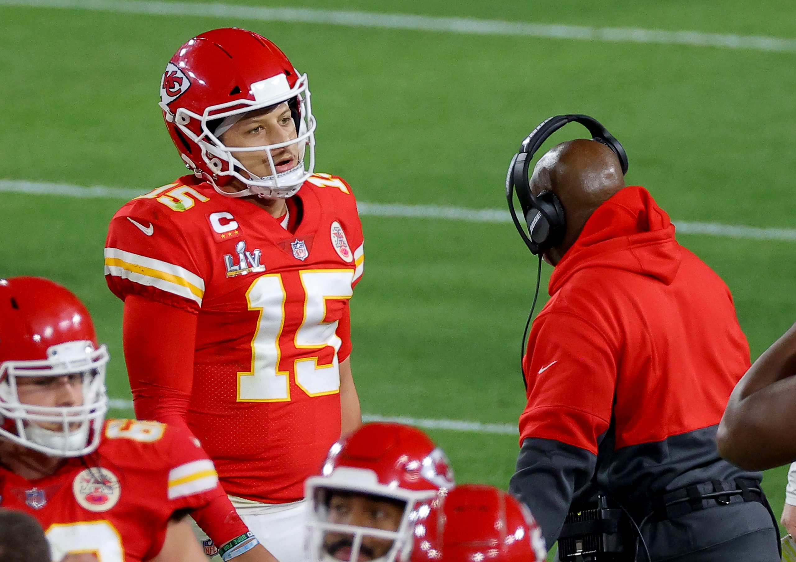 Kansas City Chiefs offensive coordinator Eric Bieniemy talks to Chiefs  tight end Travis Kelce (87) after their win over the Buffalo Bills in an NFL  divisional playoff football game, Sunday, Jan. 23