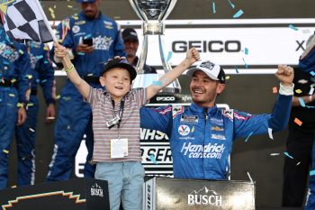 Kyle Larson, driver of the No. 5 Chevrolet, celebrates with his son, Owen, in victory lane after winning the NASCAR Cup Series Championship at Phoenix Raceway on Nov. 7, 2021.