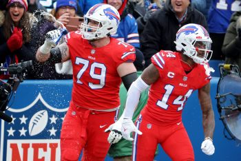 Stefon Diggs of the Buffalo Bills celebrates his touchdown with teammate Spencer Brown in the second quarter over the Carolina Panthers at Highmark Stadium on December 19, 2021 in Orchard Park, New York. The Buffalo Bills clinch a playoff spot in Week 17 with a win and some help.