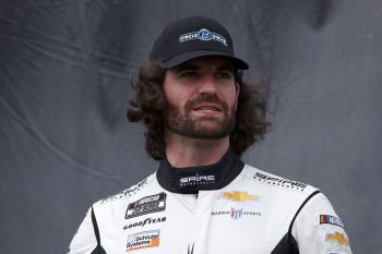 Corey LaJoie, waits backstage during pre-race ceremonies at the NASCAR Cup Series Hollywood Casino 400 at Kansas Speedway on Oct. 24, 2021, in Kansas City, Kansas.