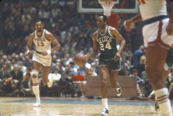 Boston Celtics star Sam Jones bringing the ball up the court.