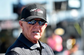 Joe Gibbs looks on during race