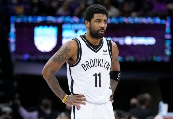 Brooklyn Nets guard Kyrie Irving stands on the court in Sacramento.