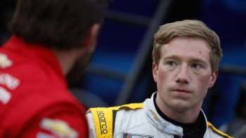 Tyler Reddick, driver of the No. 8 Chevrolet, looks on in the garage area during practice for the NASCAR Cup Series Daytona 500 at Daytona International Speedway on Feb. 15, 2022.