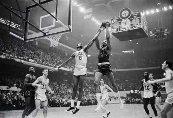 Bill Russell and Wilt Chamberlain battle down low.