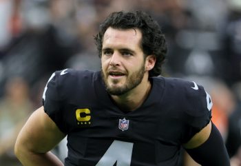 Quarterback Derek Carr of the Las Vegas Raiders smiles as he warms up before a game against the Denver Broncos.