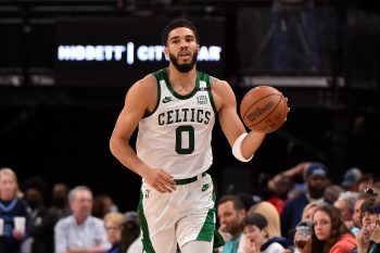 Jayson Tatum of the Boston Celtics brings the ball up court.