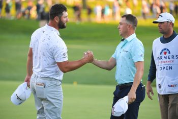 Jon Rahm shakes hands with Justin Thomas.