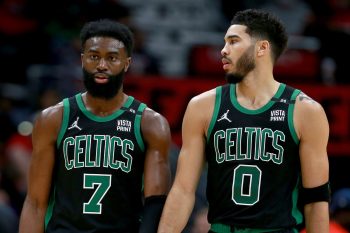 Jaylen Brown #7 of the Boston Celtics and Jayson Tatum #0 stand on the court.