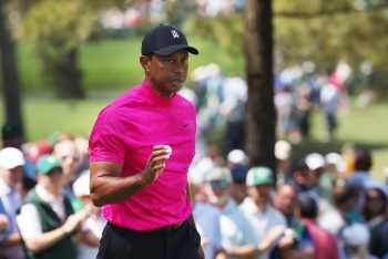 Tiger Woods waves to the crowd after making a par.