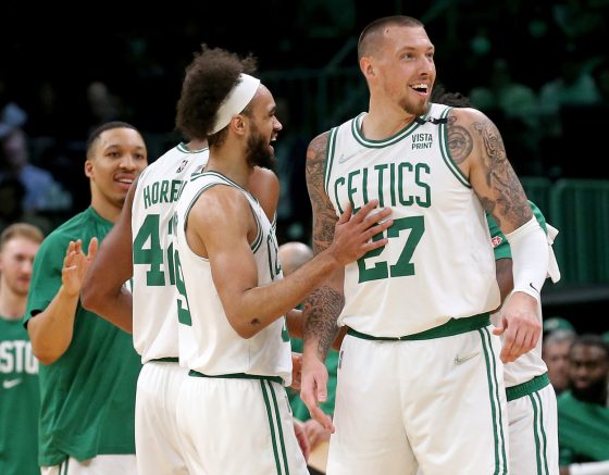 Derrick White of the Boston Celtics celebrates with Daniel Theis #27.