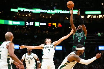 Jaylen Brown of the Boston Celtics shoots the ball while guarded by Grayson Allen of the Milwaukee Bucks.