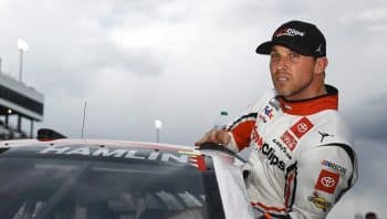 Denny Hamlin, driver of the No. 11 Toyota, enters his car during qualifying for the NASCAR Cup Series Blue-Emu Maximum Pain Relief 400 at Martinsville Speedway on April 8, 2022.