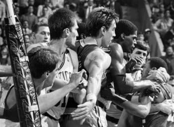 Boston Celtics player Rick Carlisle is held back by Fred Roberts after a fight broke out with Indiana Pacers player John Long.