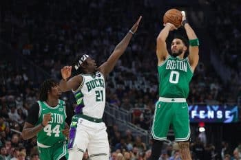 Jayson Tatum of the Boston Celtics shoots over Jrue Holiday.