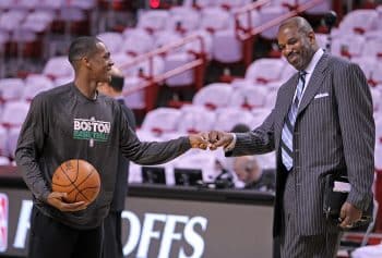 Rajon Rondo and Celtics radio commentator Cedric Maxwell bang fists.