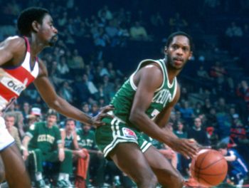 Nate Archibald of the Boston Celtics backs in on Kevin Porter of the Washington Bullets.