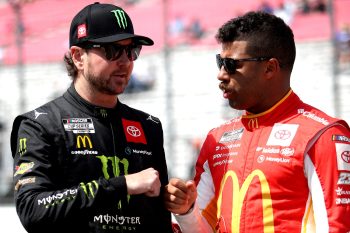 Kurt Busch and Bubba Wallace fist bump on the grid during qualifying for the NASCAR Cup Series Enjoy Illinois 300 at WWT Raceway on June 4, 2022 in Madison, Illinois.